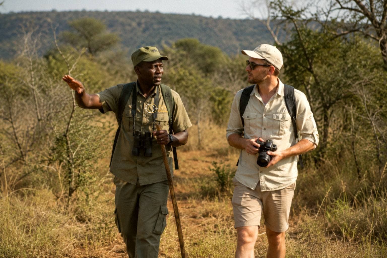 eXvo guide walking with guests through the bush on a Tanzania safari
